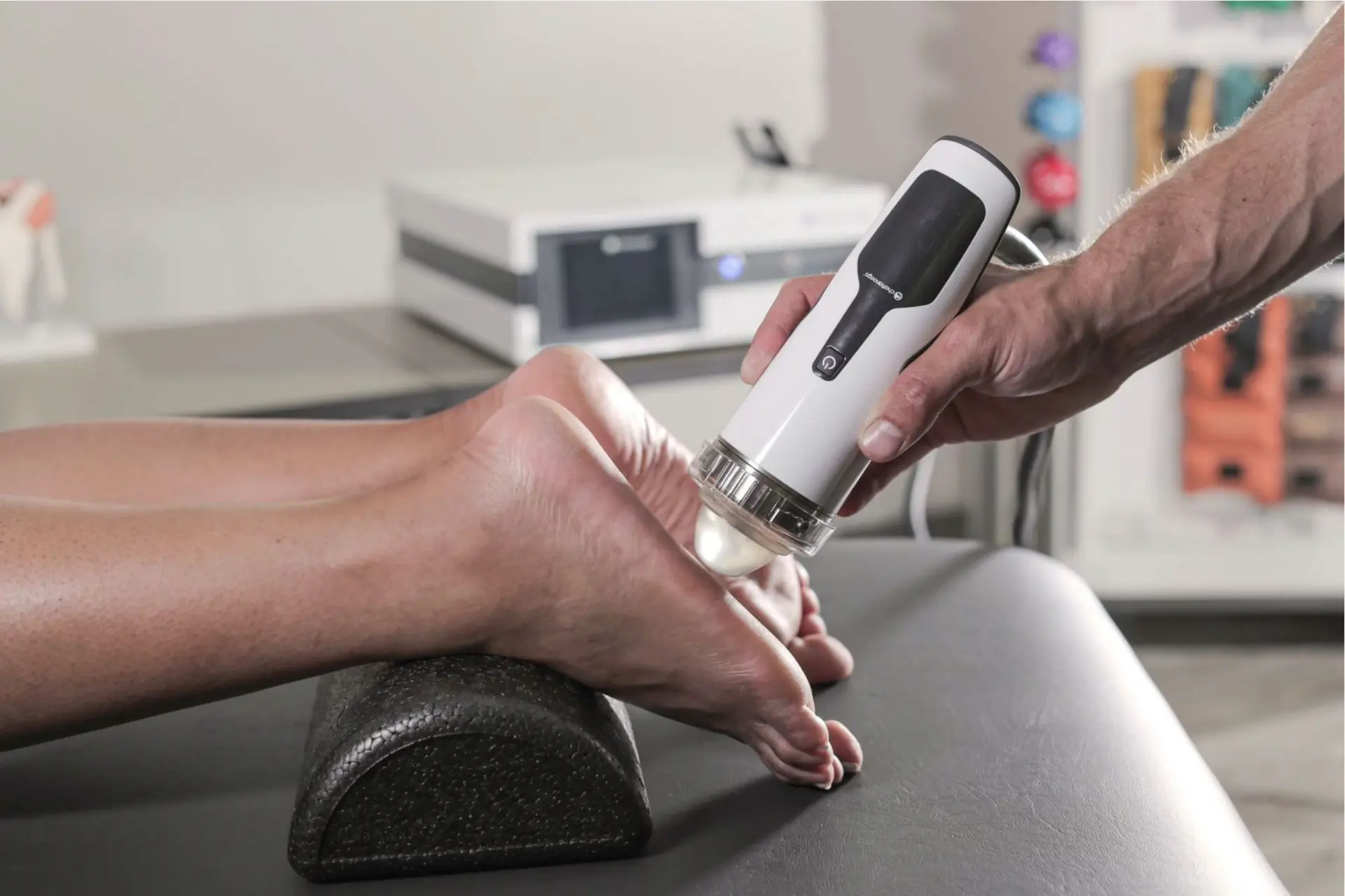 Clinician delivering focused shockwave therapy treatment