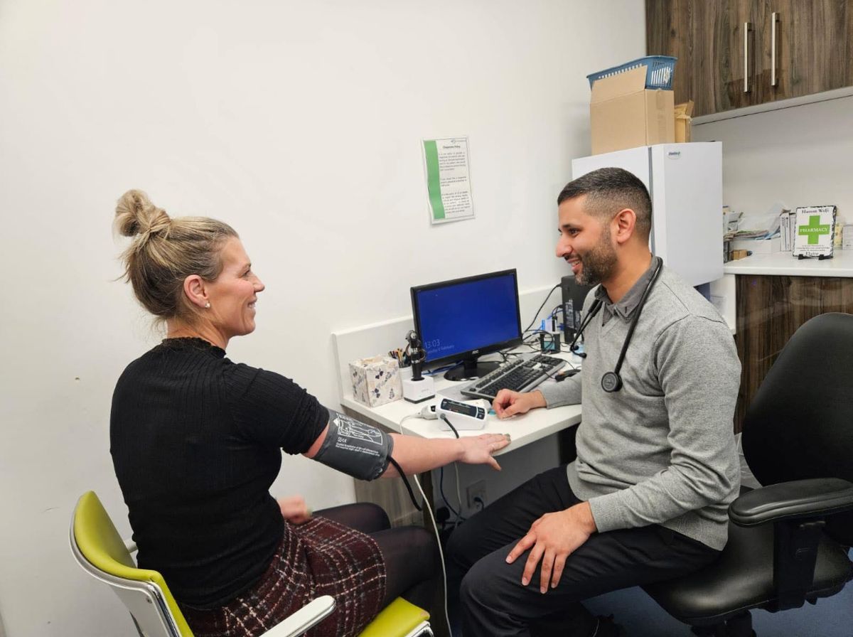A pharmacist at Acorn Pharmacy Huntingdon helping a patient